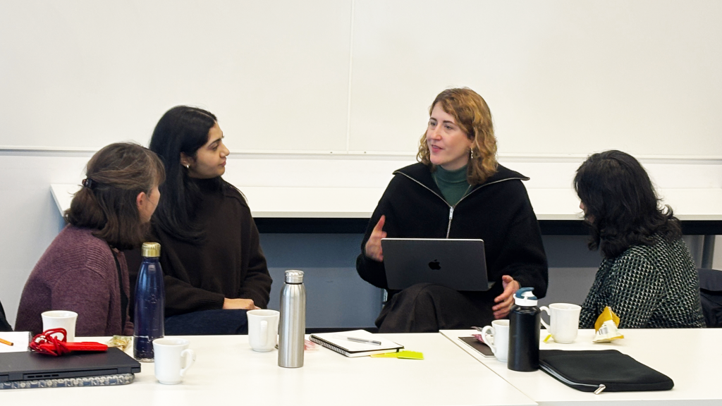 Three of the Centre researchers discuss with each other during one of the discussion sessions. 