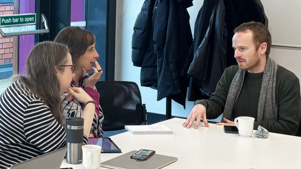 Three of the Centre researchers discuss with each other during one of the discussion sessions. 