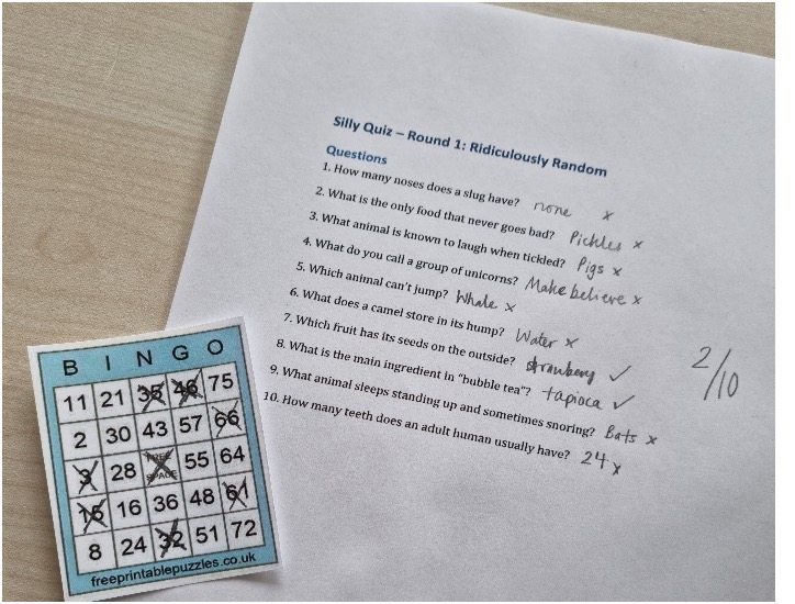 A completed bingo sheet and quiz answer sheet, with a score of 2/10.