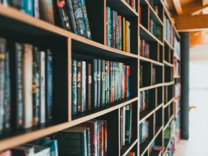 A perspective view of a bookshelf that is full of books.